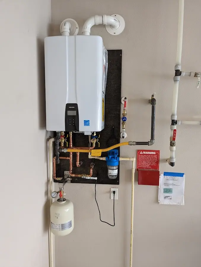 Professional plumber installing copper piping in a Mercedes home